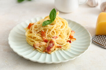 Plate with tasty pasta carbonara on light background, closeup
