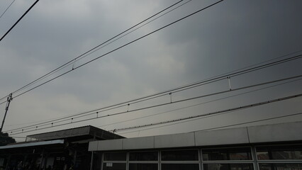 The condition of the cable line that is above used by the electric rail train on a cloudy afternoon

