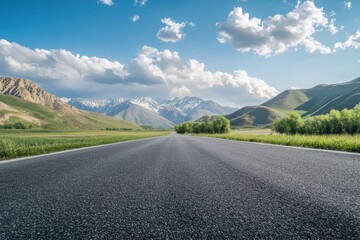 Fototapeta premium View of empty asphalt road with cloudy mountains on sunny day