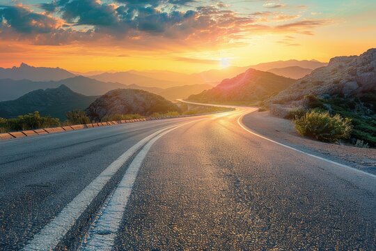 Mountain landscape and asphalt highway road at sunset from above