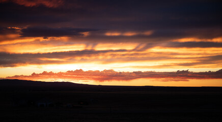 Dramatic dark red and yellow sunset with clouds