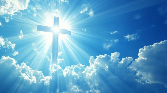 Image of a Christian cross with the rays of God on a blue sky background.