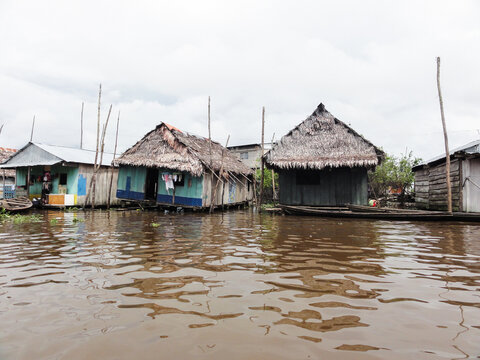 Colorful wooden stilt houses are floating on the amazon river in the belen district of iquitos, peru