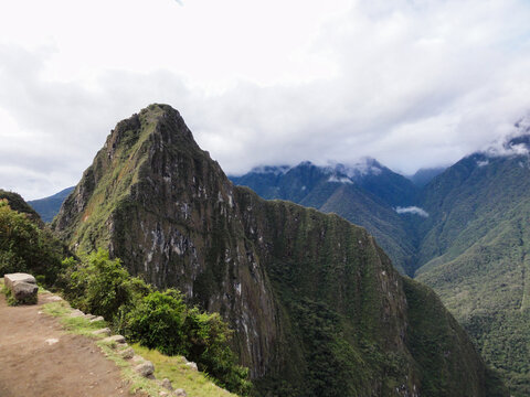 Dramatic landscape showing a hiking trail leading to a mountain peak in the andes mountains of peru