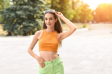 Beautiful young woman with stylish sunglasses outdoors