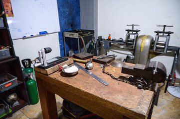 Jeweler's workbench featuring tools for creating handmade jewelry in a workshop