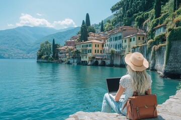 Happy female freelancer working remotely by blue lake como in italy