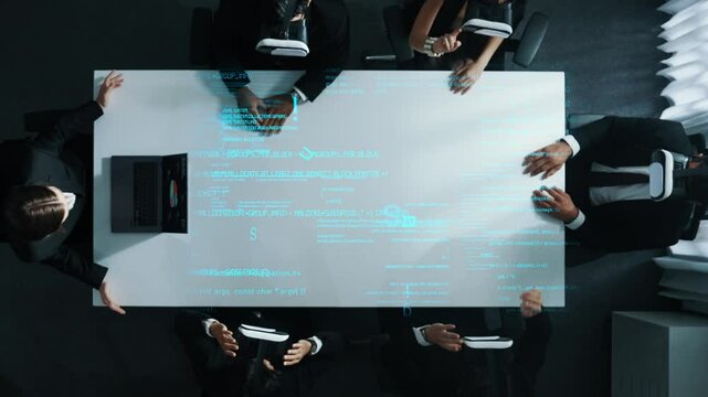 Top view of diverse data analysts wearing VR headsets stands coding program holographic while using hand gestures to manipulate programing engineering prompt from the manager laptop. Directorate.