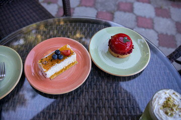 A table with two plates of desserts, one of which is a blueberry cake