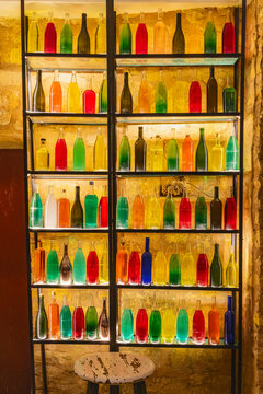 Tataouine, Tunisia. A rack of bottles filled with colored water.