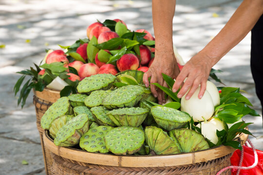 Vendor selling peaches and lotus root, Yangshuo, Guangxi Province, China
