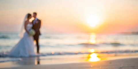 Softly blurred image of a beach wedding with a sunset in the background.