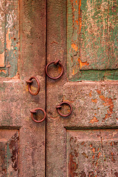 India, West Bengal, Kolkata. Door with ornamental rings.