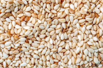 top view of background full of white sesame seeds.
