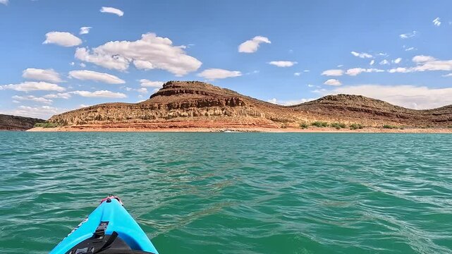 Mountain Lake summer recreation boat and kayak. Southern Utah desert Quail Creek reservoir. Summer recreation on the water and State Park. Outdoor family fun in boat, kayaks and swimming. 
