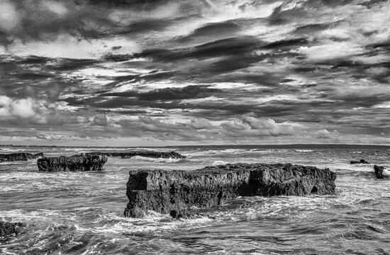 Crashing waves rolling off the volcanic rock outcroppings.