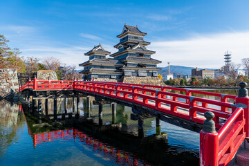 The Matsumoto Castle as seen from the bridge with the city buildings in the background, Japan