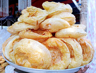 selling traditional sweet dish khajauli or Khaja at matia mahal