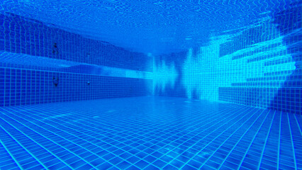 Background of  underwater image of the tone blue swimming pool at the resort	
