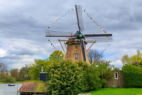 Netherlands, North Holland. Weesp. Typical Molen, windmills with Dutch flags. Molen Vriendschap, the Friendship windmills.