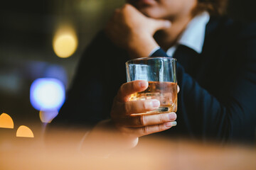 A young businessman holds a glass of whiskey, toasting with friends at an upscale bar. The scene captures the essence of luxury and celebration, with a focus on camaraderie and the nightlife atmospher
