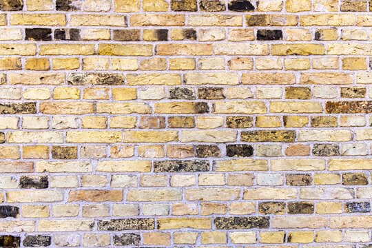 Netherlands, North Holland, Enkhuizen. Pattern of yellow and black in a brick wall.