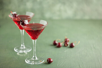 Cherrytini. Red alcoholic cherry martini cocktail with cherry garnish in martini glasses