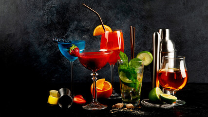 Summer cocktail in glasses on a dark background. Bar delicious drinks