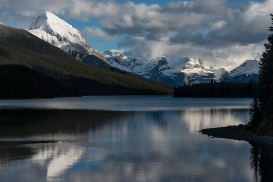 Canada, Alberta. Snow and cloud covered peaks surrounding Maligne Lake, Jasper National Park.