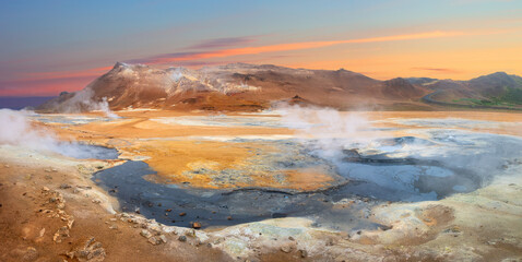 Panoramic view of geothermal area. Volcanic activity and hot springs, fumarole fumes.  Wild nature landscape. Iceland, Northern Europe.