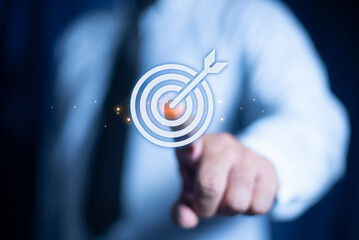 Businessman hand touching to target dart board icon with arrow for setup and achievement objectives target, strategy, planning, development for business investment concept.