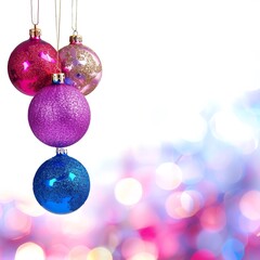 Obraz premium Colorful Christmas ornaments hanging against a bright, blurred background. Ideal festive image representing holiday decoration and celebration.
