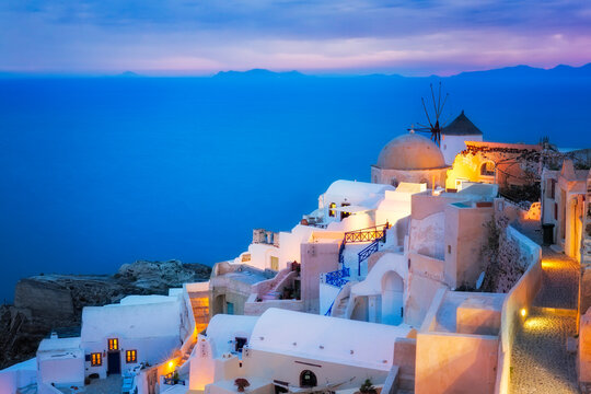 Europe, Greece, Santorini, Oia. Sunset on coastal town.