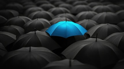 Blue umbrella in a sea of black umbrellas, standing out and being unique, contrast concept