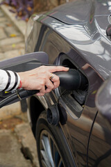 close up of  hand  holding a electric vehicle charger