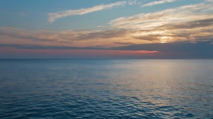Fototapeta premium Scenic landscape view of a lake under great blue sky and sunset in horizon, reflection of clouds on clear water