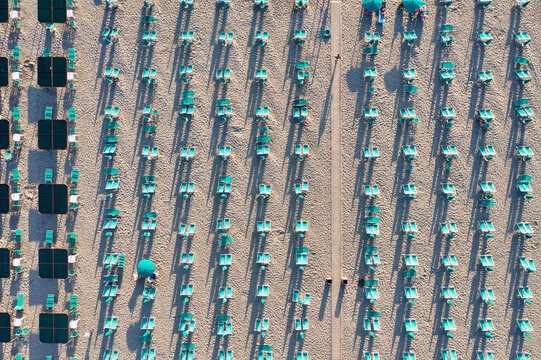 Italy, Tuscany, Torre del Lago Puccini, boathouse and neatly ordered beach chairs and umbrellas