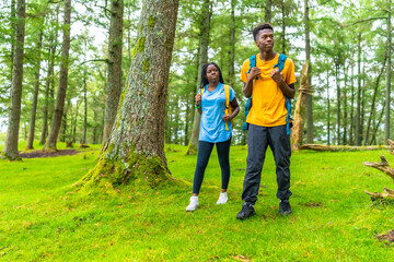 Fototapeta premium Young african friends hiking in the forest