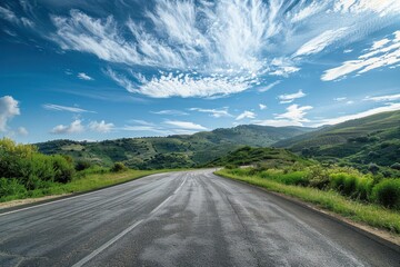 Naklejka premium Road and hill scenery under blue sky