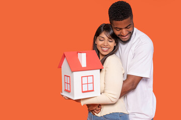 Couple Celebrating Homeownership With Miniature House Model