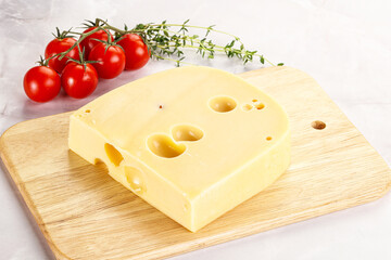 Maasdam cheese brick over board