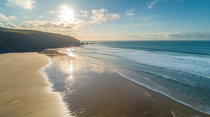 Obraz premium Aerial View of a Sandy Beach with Rolling Waves