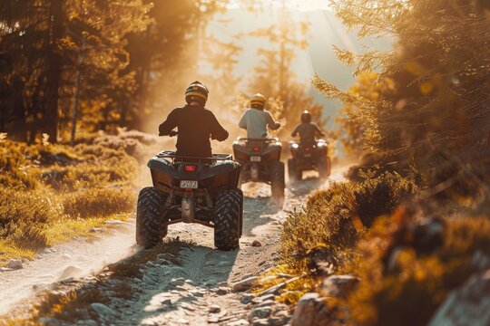 Young individuals do extreme quad biking in natural surroundings