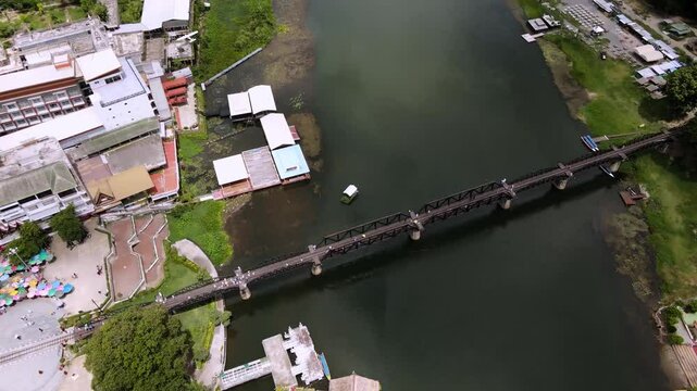 The Bridge River Kwai, Kanchanaburi, Thailand. The Death Railway, World War II, by the Japanese Army, which conscripted approximately 61,700 Allied prisoners of war. Opened 1943. Drone view. Video.