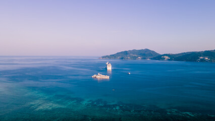 Paradise beach Phuket Patong. aerial top view amazing freedom beach small white sand beach with perfect nature. white wave hit the rock around island. green forest peaceful. green sea, landscape.