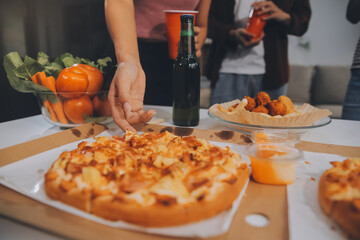 Group of young friends eating pizza.Home party.