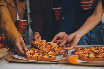 Group of young friends eating pizza.Home party.