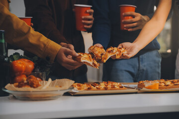 Group of young friends eating pizza.Home party.