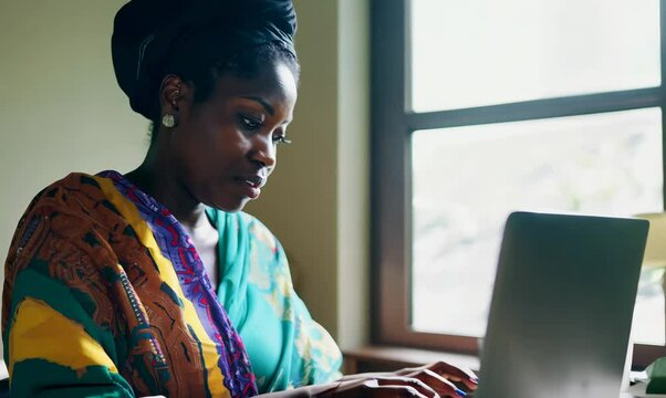 Malawian Woman Creating Budget Spreadsheet at Home