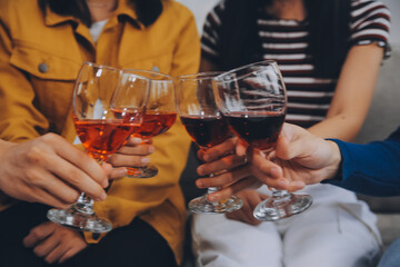Happy friends making a toast with beer before eating pizza in a shared apartment.